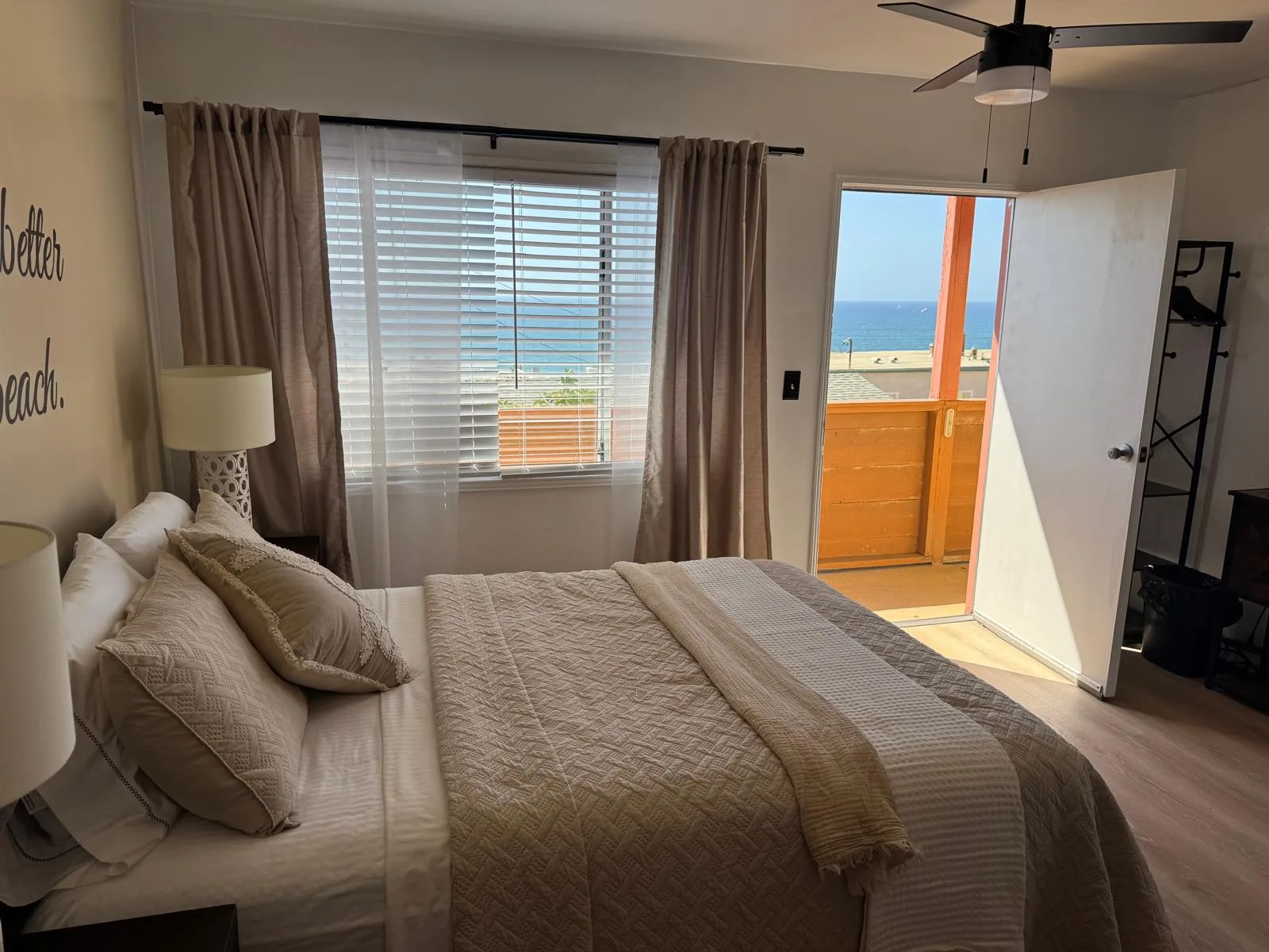 Bedroom with open balcony door facing the Pacific Ocean